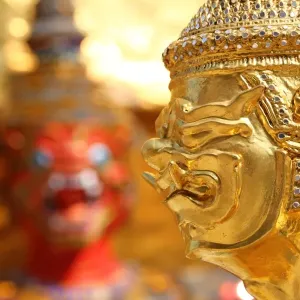 Golden Kinnara staue and Yaksha Demon at the Wat Phra Kaew Royal Palace complex in Bangkok Golden Kinnara staue and Yaksha Demon at the Wat Phra Kaew Royal Palace complex in Bangkok