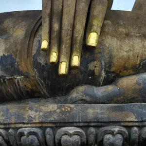 Hand on a Buddha statue at Wat Mahathat temple, Sukhotai, Thailand