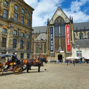 Horse drawn carriage and the Nieuwe Kerk church in Dam Square in Amsterdam, Holland