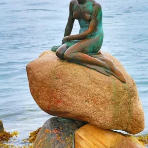 The Little Mermaid statue sitting on rocks, Copenhagen, Denmark