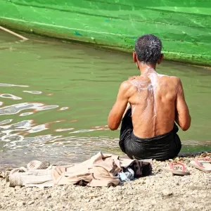 Man washing in the Ayeryarwaddy River in Old Bagan, Bagan, Myanmar (Burma)