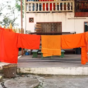 Orange Buddhist Monk clothes and robes on a washing line, Vientiane, Laos Orange Buddhist Monk clothes and robes on a washing line, Vientiane, Laos