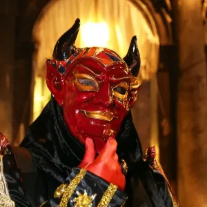 Person wearing a demon mask and costume at the Venice Carnival
