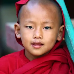 Portrait of a young Buddhist monk playing at a temple in Amarapura, Mandalay, Myanmar