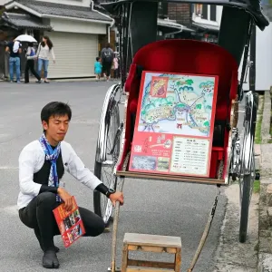 A rickshaw and its driver at Itsukushima Shinto Shrine on Miyajima Island, Hiroshima, Japan