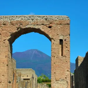 Ruined archway in the ancient Roman city of Pompeii and Mount Vesuvius, Italy Ruined archway in the ancient Roman city of Pompeii and Mount Vesuvius, Italy