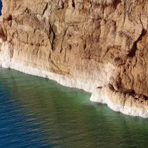 Salt deposits on the rocky shoreline of the Dead Sea, Jordan