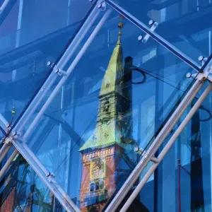 Scandic Hotel clock tower reflected in a diamond shaped glass window in Copenhagen