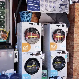 Self-service street launderette for tourists to do laundry on Koh Samet island, Thailand