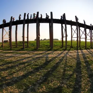 Shadows of the U Bein Bridge across the Taungthaman Lake at sunset in Amarapura