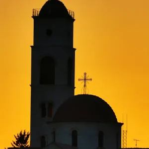 Silhouette of the Greek Orthodox Church dome and tower at sunset in Amman, Jordan