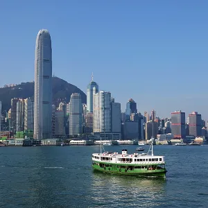 Two Star Ferries crossing Victoria Harbour with the city skyline in Hong Kong, China Two Star Ferries crossing Victoria Harbour with the city skyline in Hong Kong, China