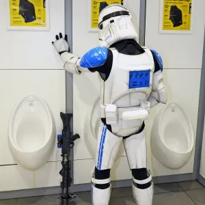 A Star Wars Stormtrooper takes a loo break in the toilet at MCM London Comic Con