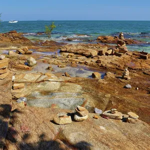 Stone cairns built on rocks at Tubtim beach on Koh Samet island, Thailand