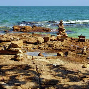 Stone cairns built on rocks at Tubtim beach on Koh Samet island, Thailand