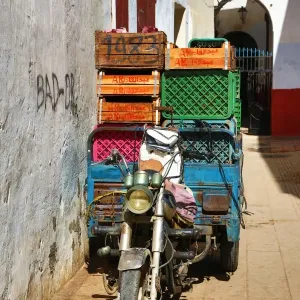 Street scene with a loaded motorcycle in the Medina of Rabat, Morocco