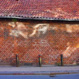 Street scene with old brick wall with light reflection in Copenhagen, Denmark