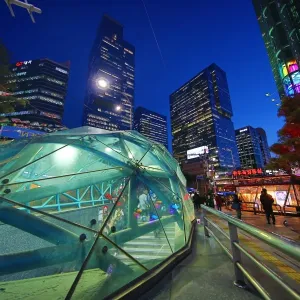 Tall modern buildings and office blocks at dusk with the glass of Gangnam metro station