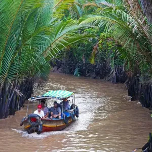 Tourist boat on canal on Con Lan (Unicorn) Island, near My Tho, Mekong Delta, Vietnam Tourist boat on canal on Con Lan (Unicorn) Island, near My Tho, Mekong Delta, Vietnam