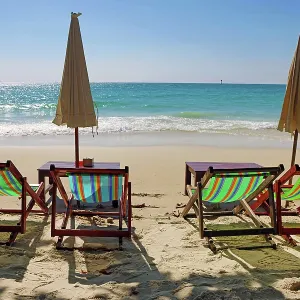 Tourists sunbathing on Sai Kaew beach on Koh Samet island in Thailand