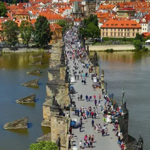 Tourists walking over the Charles Bridge over the Vltava River in Prague, Czech Republic