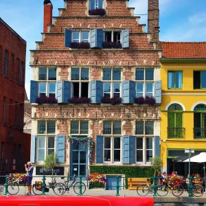 Traditional building and houseboat on a canal, Ghent, Belgium