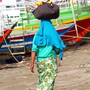 Woman carrying bag on her head in Old Bagan, Bagan, Myanmar (Burma)
