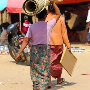 Woman carrying a carpet on her head in Old Bagan, Bagan, Myanmar (Burma)
