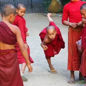 Young Buddhist monks playing at a temple in Amarapura, Mandalay, Myanmar (Burma)