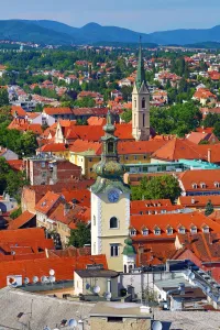 Churches: Aerial view of rooftops and the towers of St Marys Church and St Francis Church in Zagreb
