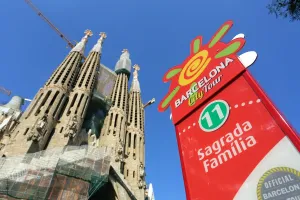 Tourism: Barcelona City Tour bus stop sign for tourists at the Basilica de la Sagrada Familia cathedral in Barcelona