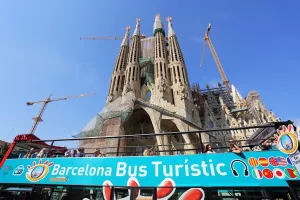 Tourism: Barcelona City Tour sightseeing Touristic bus for tourists at the Basilica de la Sagrada Familia cathedral in Barcelona