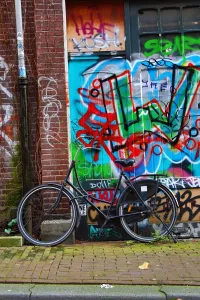 Bicycle and colourful graffiti street scene in Amsterdam, Holland