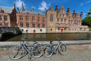 Belgium: Bicycles leaning against a canal wall with medievel buildings, Bruges, Belgium