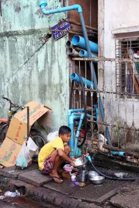 Rangoon: Boy washing dishes in the street, Yangon, Myanmar