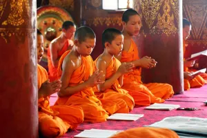 Luang Prabang, Laos: Buddhist monks at worship in Wat Sen temple in Luang Prabang, Laos