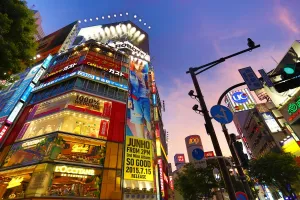 Tokyo, Japan: Buildings at sunset at the pedestrian crossing at the intersection in Shibuya, Tokyo