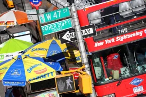 Tourism: Busy street scene with red tourist sightseeing bus