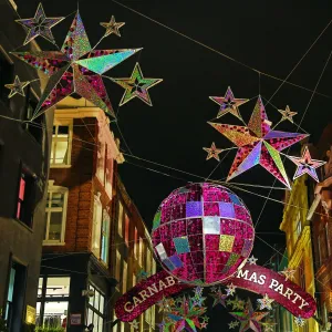 Britain: Carnaby Street Christmas Decorations shaped like balls and stars in London, England