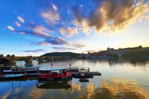 Saint: Charles Bridge over the Vltava River and boats at sunset in Prague, Czech Republic