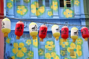 Lantern: Chinese lanterns hanging in front of colourful buildings with shutters and windows in Chinatown in Singapore