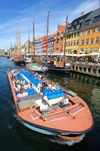 Coloured houses and a tourist sightseeing tour boat at Nyhavn Quay in Copenhagen, Denmark