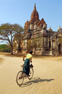 Burma: Cyclist at Thatthe Mokgo Hpaya Pagoda in Nuang U, Bagan, Myanmar (Burma)