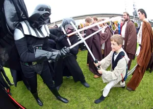 MCM London Comic Con: Darth Vader from Star Wars takes on a young Jedi Knight in a light sabre battle