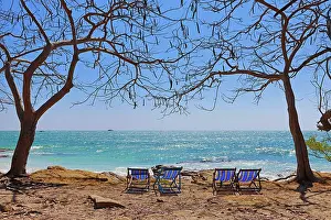 Tourism: Deckchairs on Koh Samet beach overlooking the sea on Koh Samet island, Thailand