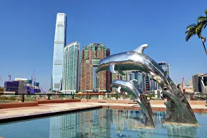 Hong Kong: Dolphin Sunset statues at Gateway Promenade in Tsim Sha Tsui with the ICC Tower and Union Square development behind