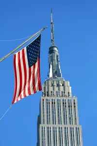 Flags: The Empire State Building and Stars and Stripes American flag, New York. America