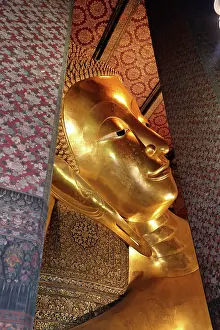 Statues: Giant gold reclining Buddha statue at Wat Pho Temple in Bangkok, Thailand