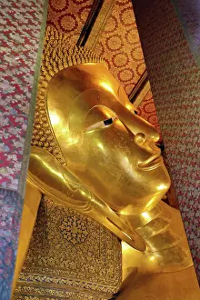 Statues: Giant gold reclining Buddha statue at Wat Pho Temple in Bangkok, Thailand