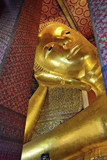 Statues: Giant gold reclining Buddha statue at Wat Pho Temple in Bangkok, Thailand